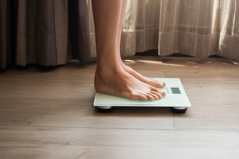 A person standing on a scale.