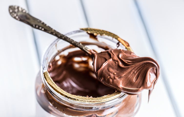 A spoon with chocolate spread