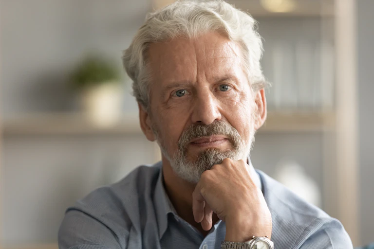 Middle-aged white man looking thoughtful