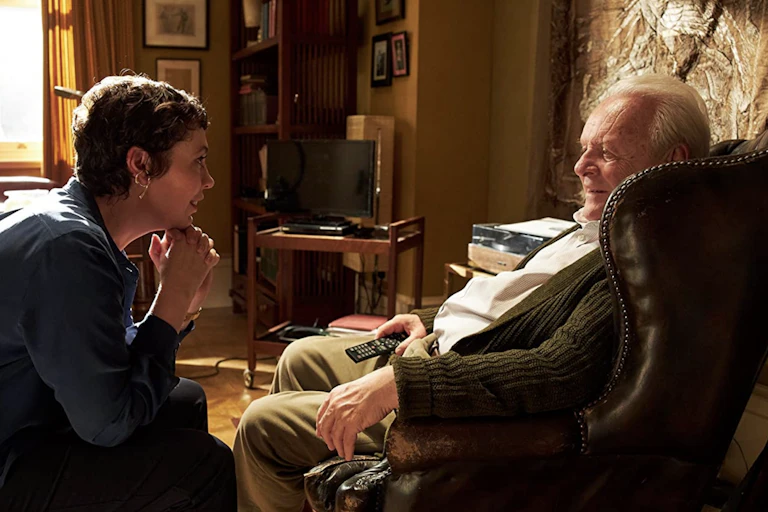 Older man and younger woman in living room