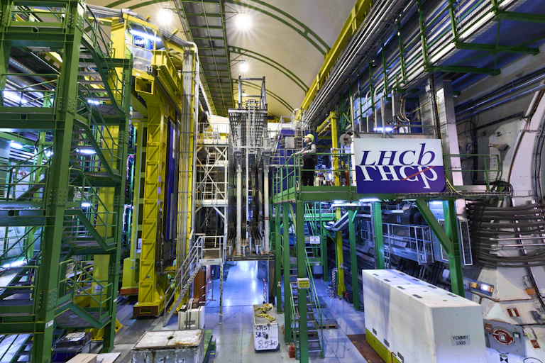 Man looking at giant metal infrastructure of the Large Hadron Collider.