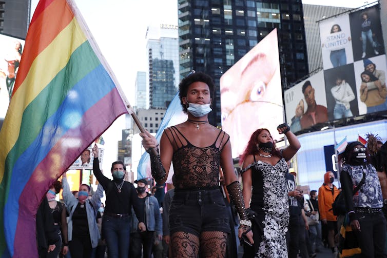 Protester holds rainbow flag during demonstration in Times Square in New York City
