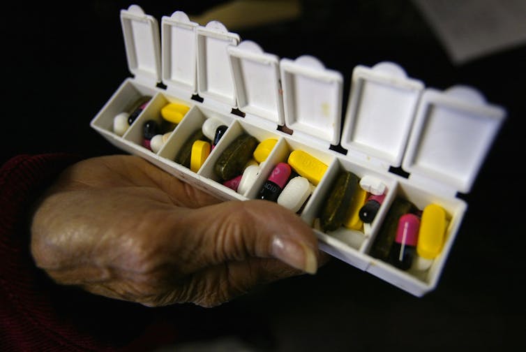 A daily pill container with several types of pills.