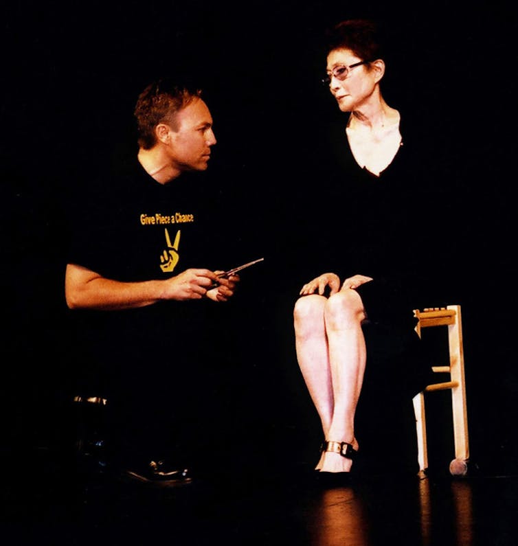 Yoko Ono and audience member onstage.