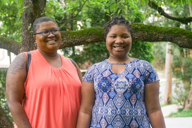 Mother stands with her nonbinary daughter