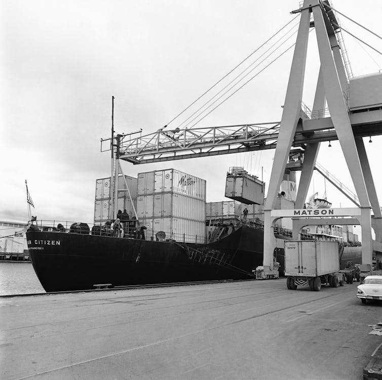 Cranes load containers onto a ship at the San Francisco pier in 1963.