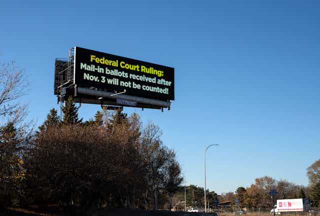 A road sign that says "Federal Court Ruling: Mail-in ballots received after Nov. 3 will not be counted!"