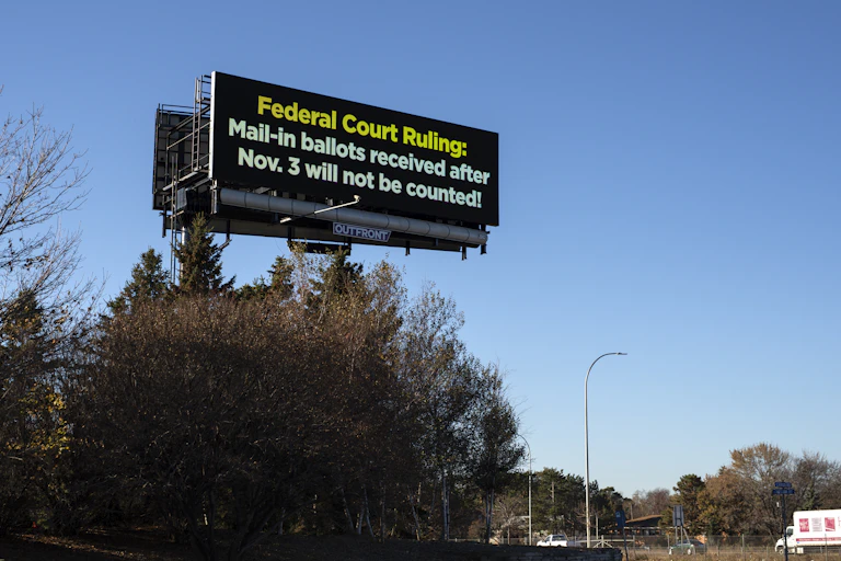A road sign that says "Federal Court Ruling: Mail-in ballots received after Nov. 3 will not be counted!"
