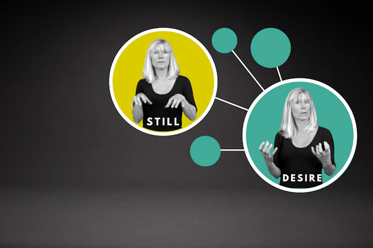 A woman signing 'Still' and 'Desire'