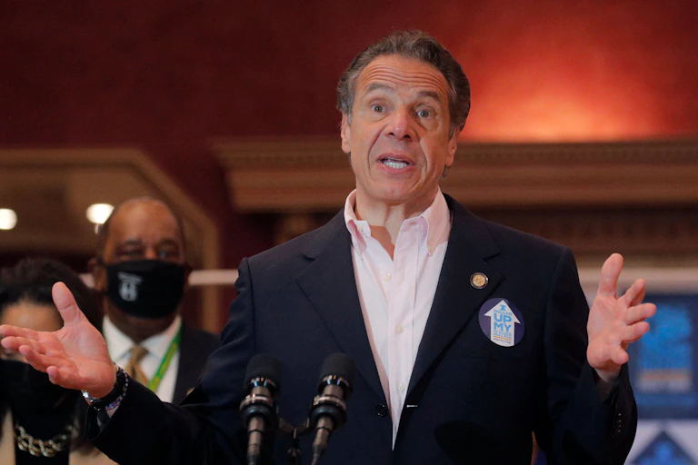 New York Gov. Andrew Cuomo speaking and gesticulating with his hands at a public gathering