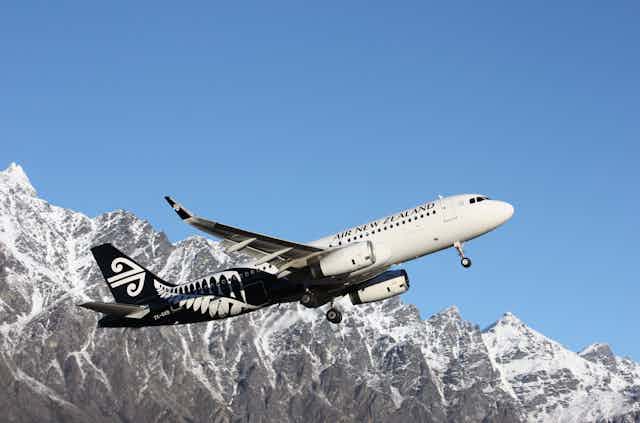 Air New Zealand jet taking off near mountains