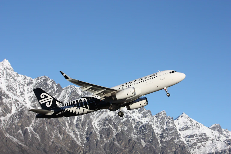 Air New Zealand jet taking off near mountains