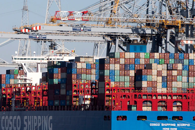 Giant shipping containers stacked on 10 high on a ship at a port