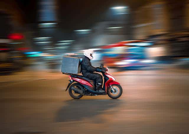 Food delivery man on scooter