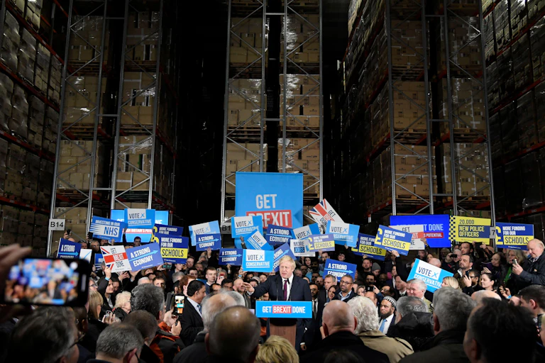 Boris Johnson pictured on the 2019 election campaign among a large crowd of supporters.