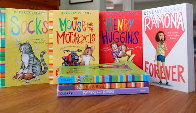 Four colorful Beverly Cleary children's books displayed upright behind a pile of three other Cleary books