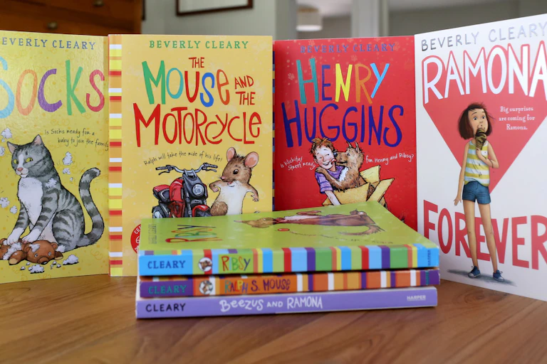 Four colorful Beverly Cleary children's books displayed upright behind a pile of three other Cleary books