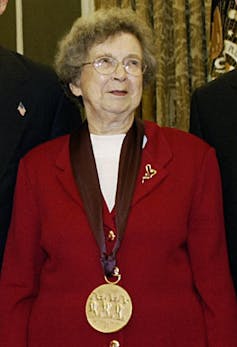 Beverly Cleary wearing a red suit and gold medal