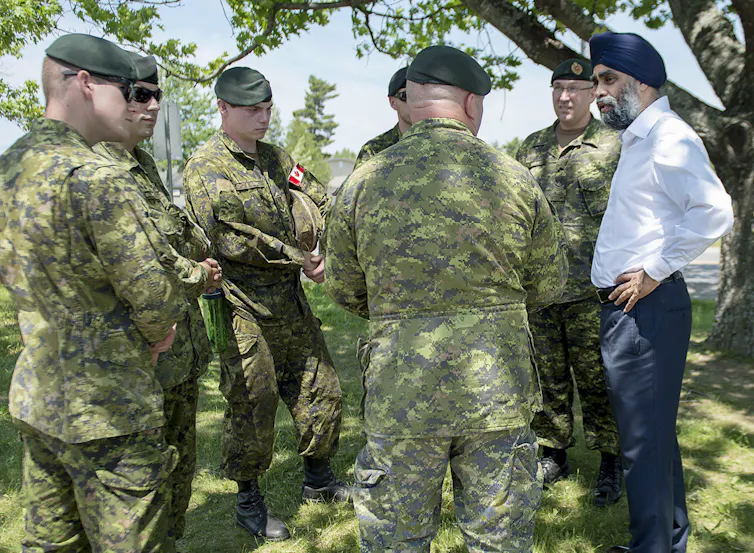Men in uniform stand in a circle