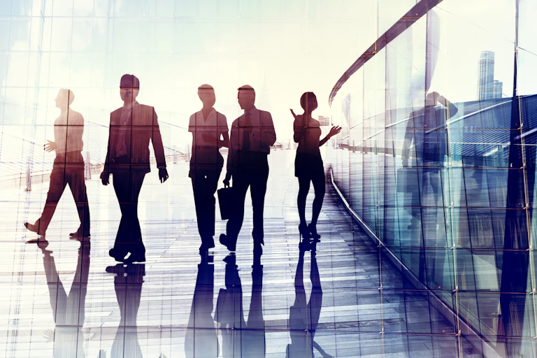 silhouetted workers in an office