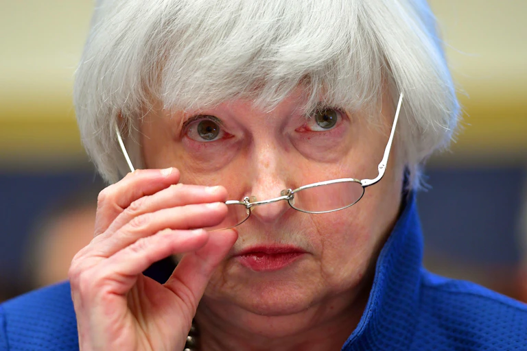 Janet Yellen adjusting her spectacles