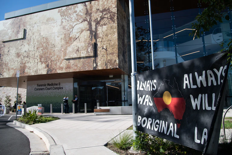 A courthouse with a banner out the front that reads 'Always was, always will be Aboriginal land'