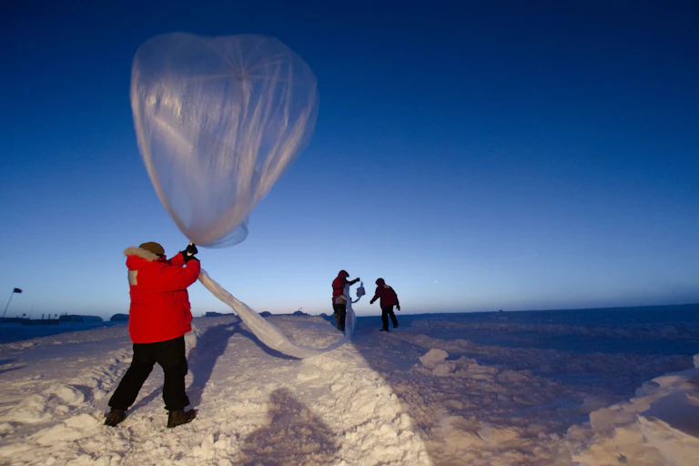 Scientists launch a balloon designed to measure ozone levels.