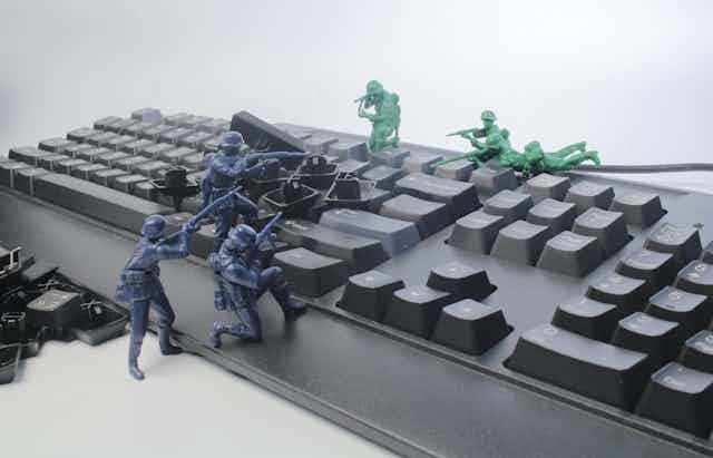 Toy soldiers fight over a computer keyboard