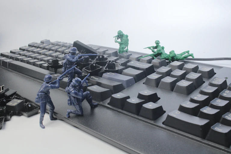 Toy soldiers fight over a computer keyboard