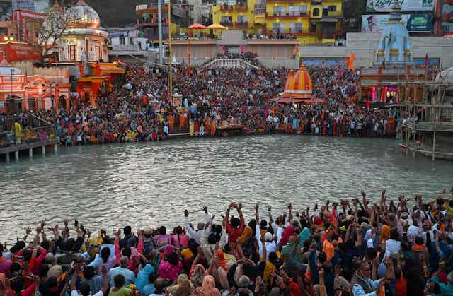Hindu devotees attend evening prayers, in Haridwar, India. on the banks of the River Ganges