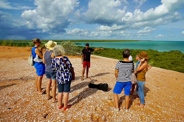 People stand by the ocean