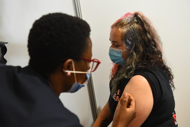 A woman receives her COVID vaccine.