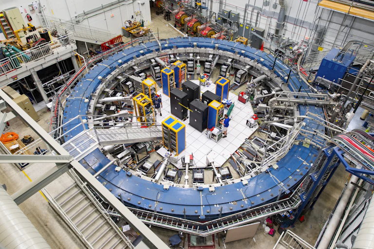The muon experiment from above, showing a large blue ring surrounded by equipment.