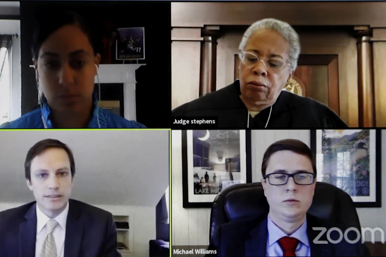 A Zoom court session, with a judge at the top right of the screen.