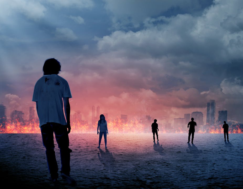 Illustration of zombie in front of burning city. 