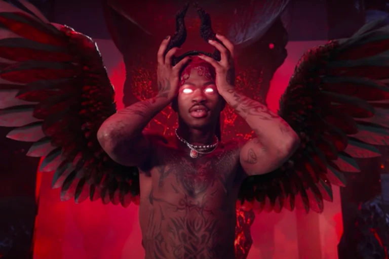 Lil Nas X puts on devil horns in a screenshot from his latest music video.