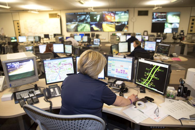 An office full of computers depicting roads and traffic data.