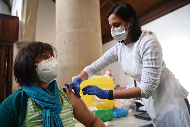 A woman being vaccinated
