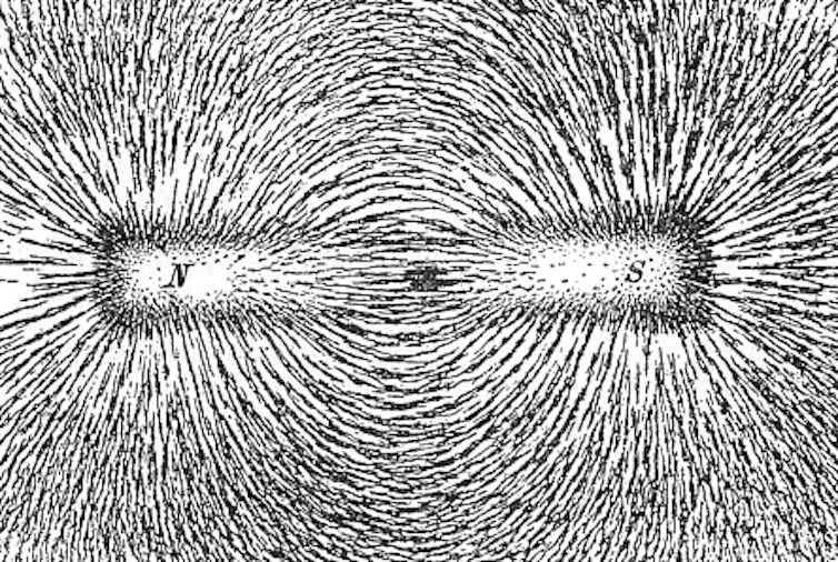 Iron filings showing the magnetic field lines of a magnet.