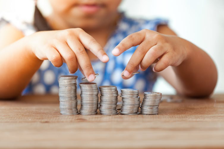 Child with coin stacks.