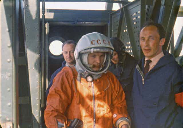 Rocket engineer Oleg Ivanovsky, right, leads Yuri Gagarin, center, to the Vostok spacecraft before the launch from what will later become known as the Baikonur cosmodrome.