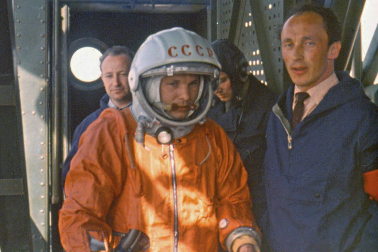 Rocket engineer Oleg Ivanovsky, right, leads Yuri Gagarin, center, to the Vostok spacecraft before the launch from what will later become known as the Baikonur cosmodrome.