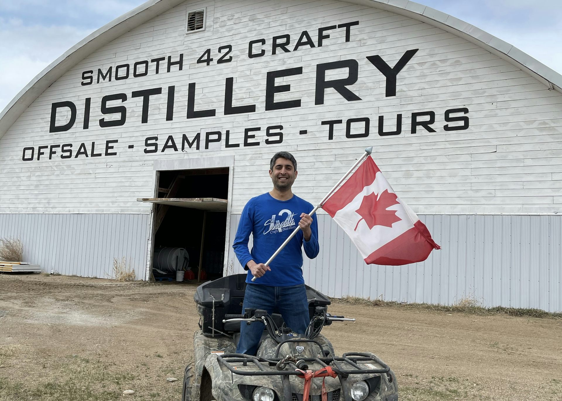 Man on ATV holding Canada flag