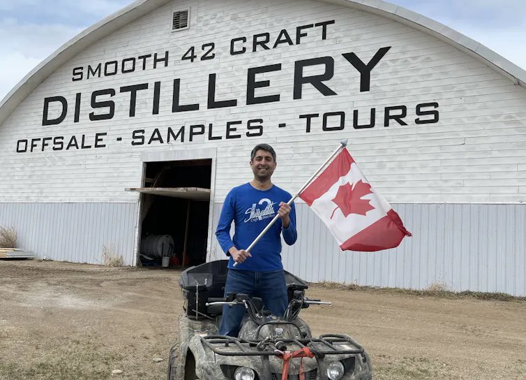 Man on ATV holding Canada flag