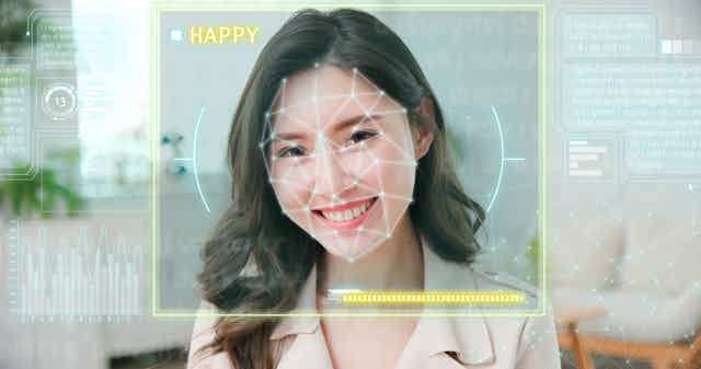 Image of a smiling woman being assessed by an AI.
