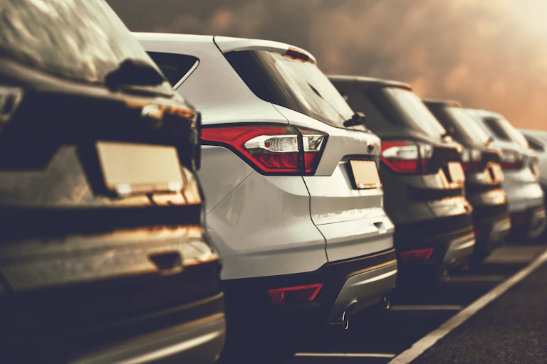 A row of SUVs in parking spaces.