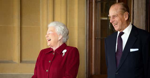 Queen Elizabeth II and Prince Philip share a joke.
