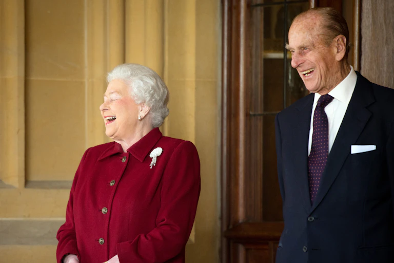 Queen Elizabeth II and Prince Philip share a joke.