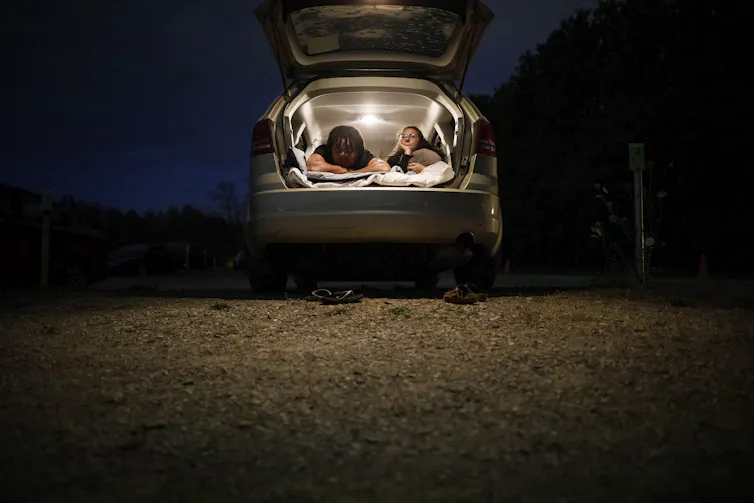 Two young people at a drive-in theatre.