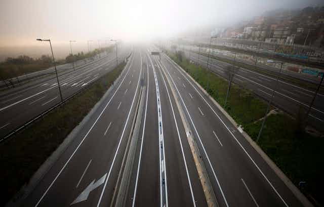 the highway leading to Barcelona is seen empty of cars